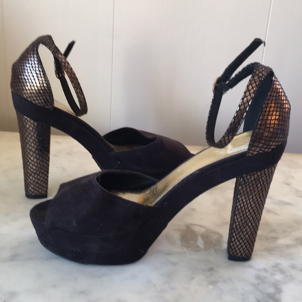 Black suede platforms with gold stacked heels.